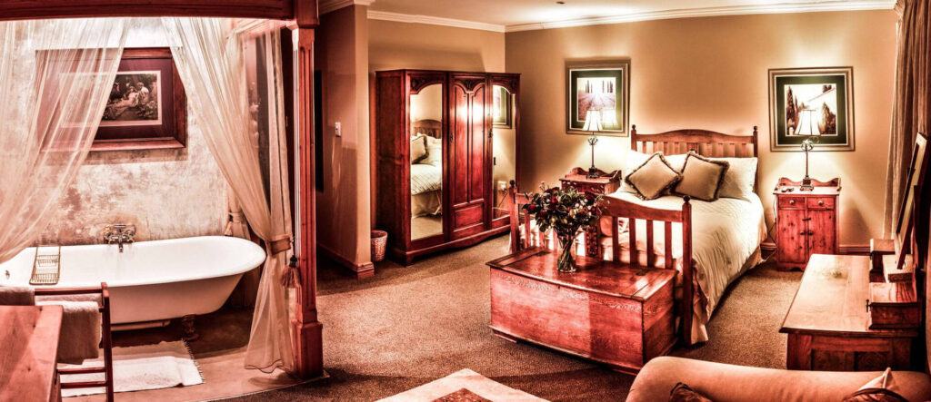 A bedroom with a queen bed and in-room bath tub.