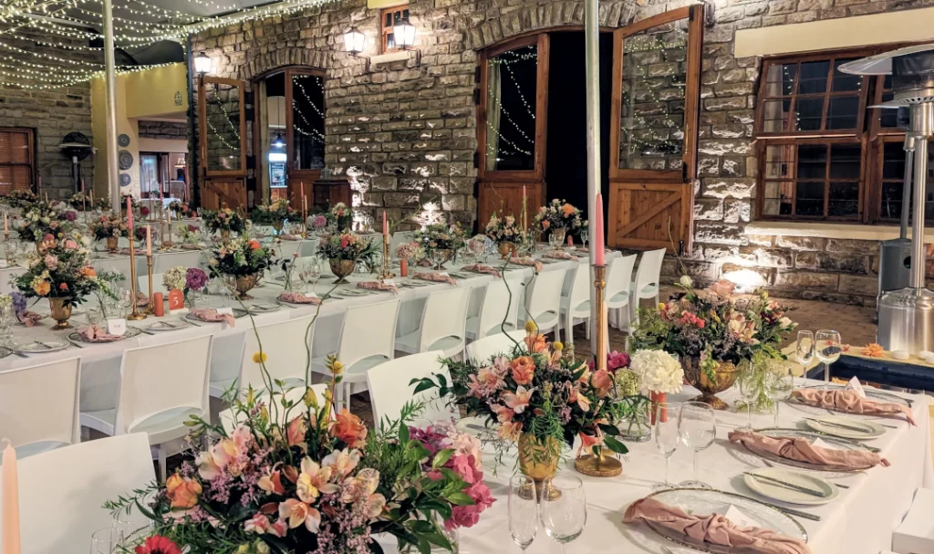 A wedding reception is set up in a stone barn.